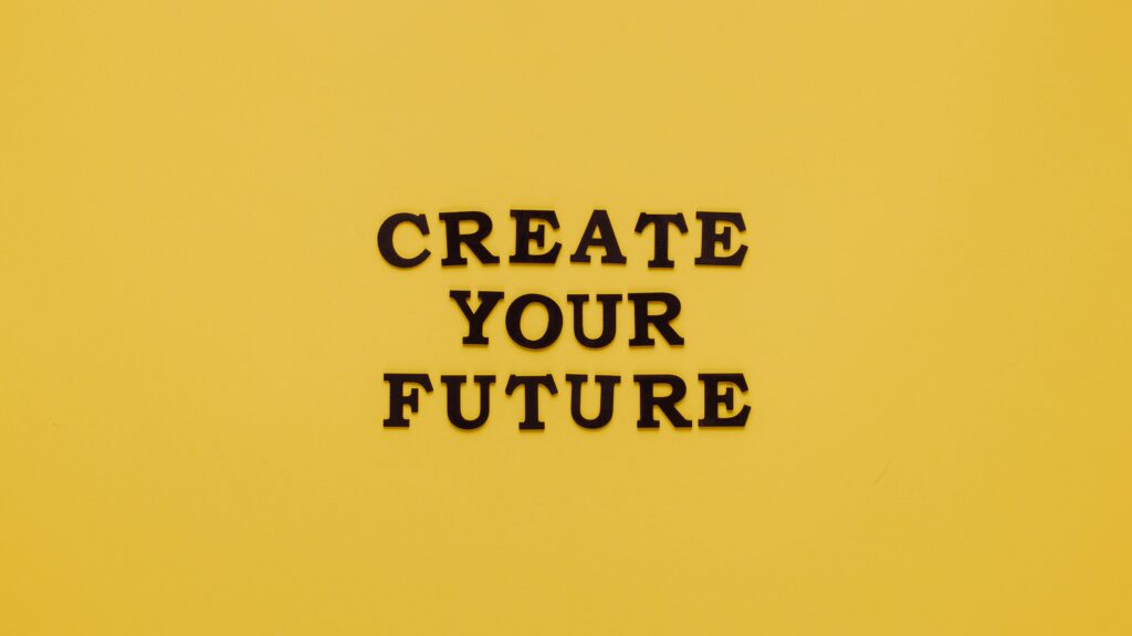 Bold text 'CREATE YOUR FUTURE' on minimalist yellow background. Inspiring design.